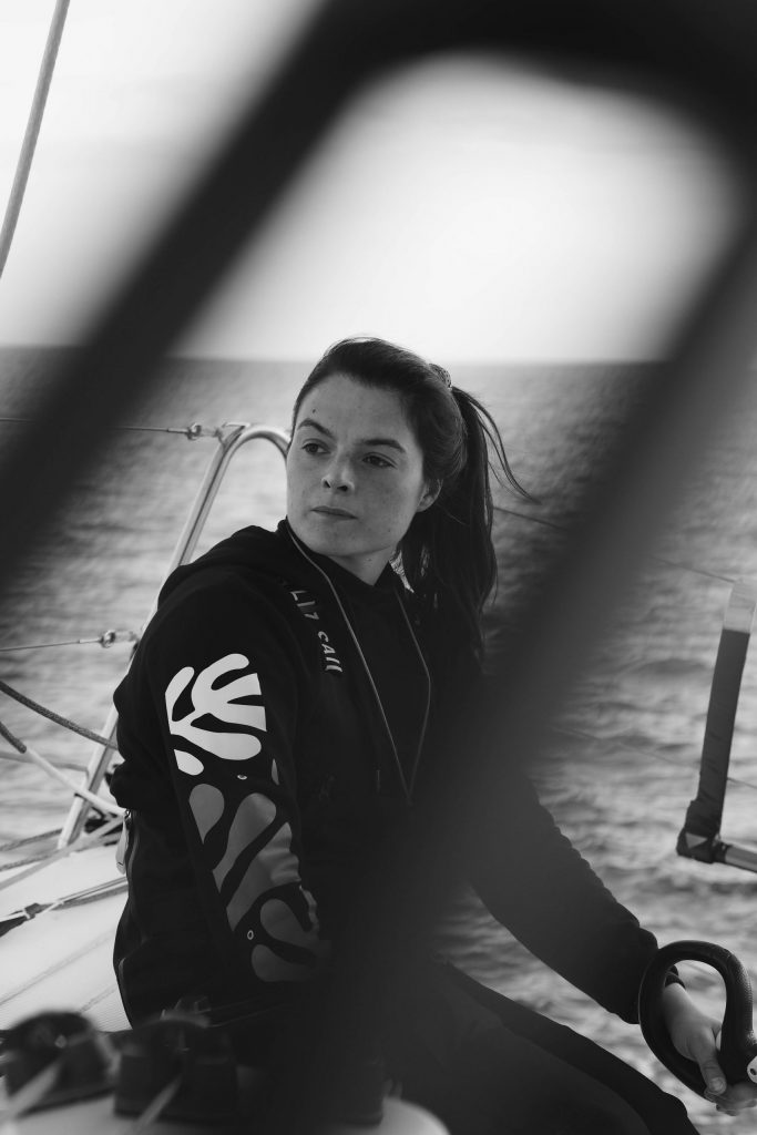 Chloé Le Bars, professional sailor, at the helm of her FIGARO 3, wearing SAILIZ overalls
